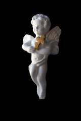 Valentine's Day, Christmas: Antique statuette of a white angel with a cross in his hands, isolated on black