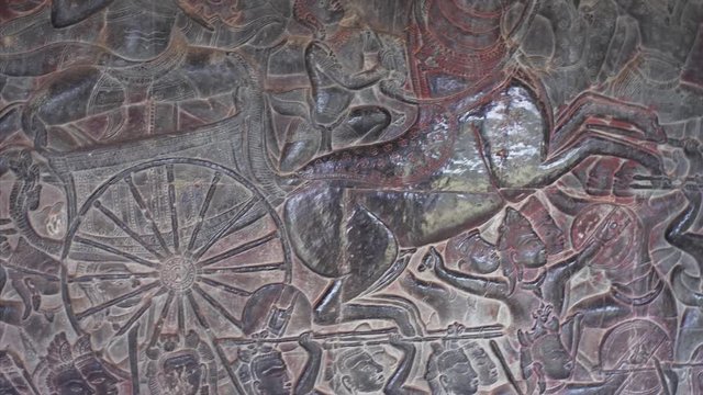 Closeup detailed view of stone carving showing great battle. Angkor Wat temple built by khmer civilization in 12th century and recognized as an important cultural site by UNESCO in 1992. Cambodia