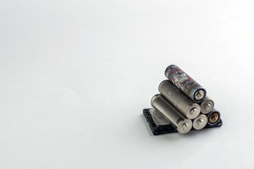 recycling of household batteries: several batteries are isolated on white, short focus, toning