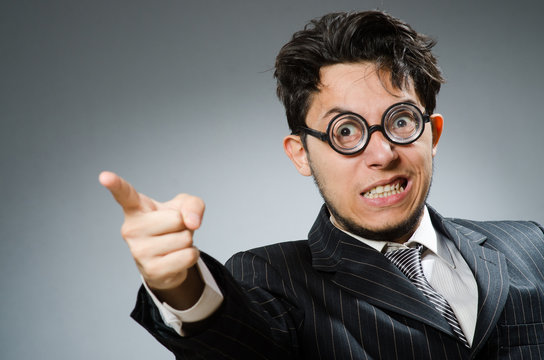 Funny nerd businessman in dark studio