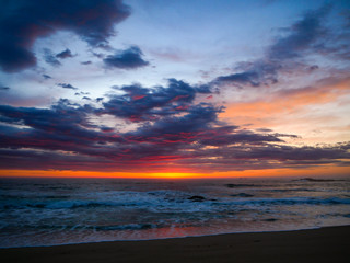 Naklejka na ściany i meble Beautiful sunset sky over the ocean at dusk with orange blue gradient sky