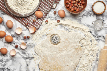 Close-up shot. Top view of a baking ingredients and kitchenware on the marble table background.