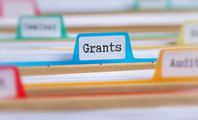 File folders with a tab labeled Grants