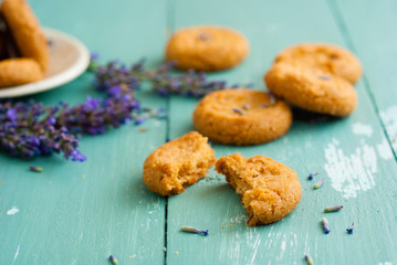 stack of lavender cookies on enamel plate, aged blue wooden table