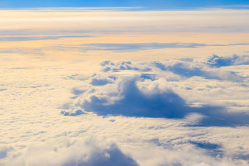 Beautiful white clouds in blue sky. View from airplane
