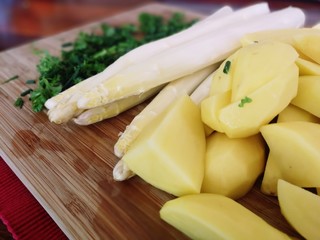 Delicious white Asparagus with potatoes and green herbs