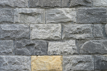 Grey granite or marble texture surface, has the yellow piece as different one. Pattern background. photo.