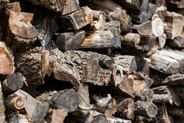 Background from stacked old brown stab wooden logs