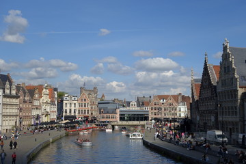 Wide view to the Leie embankments with buildings, boats and the castle of the Princes of Flanders in the background (Ghent, Belgium)
