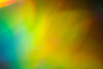Blurred green and yellow lights. Bokeh abstract background with lens flare glow effect.