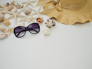 Summer background. Shells, straw hats, sunglasses