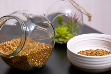 Healthy food buckwheat porridge in a plate filled with milk on a dark table with greens