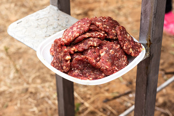 freshly  burger meat with spices on disposable plate for barbecue 