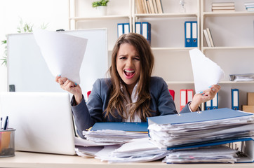 Beautiful female employee unhappy with excessive work 