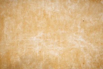 old beige wall with small holes in the wall