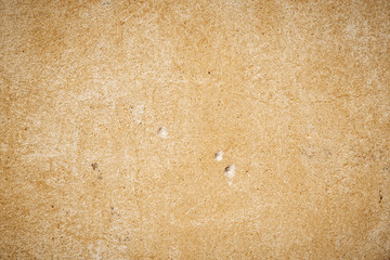 old beige wall with small holes in the wall