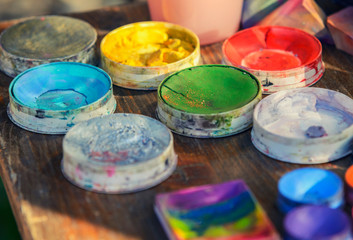 Bright colors in plastic banks. Background of colored paints.Yellow, green, red, orange, blue...