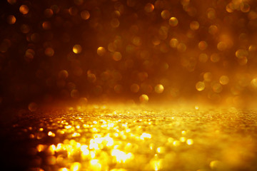 glitter vintage lights background. black and gold. de-focused