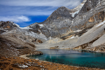 Obraz premium Five Color Lake at the base of Chenrezig, holy snow mountain in Daocheng Yading Nature Reserve - Garze, Kham Tibetan Pilgrimage region of Sichuan Province China. Beautiful Deep Blue Colored Water