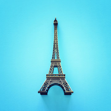 Paris symbol Eiffel Tower over blue background