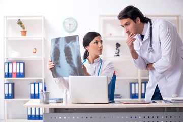 Two young doctors working in the clinic 