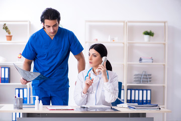 Two young doctors working in the clinic 