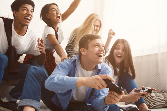 Teenagers having fun, playing video games online