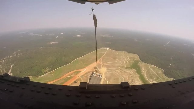Jeeps with parachutes dropped out of C-130 plane