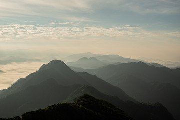 Obraz premium scenic mountain lined with alternates. The morning sun shines and fog covered the mountain. Doi KALHEPU, Mae Moei, Tak in Thailand