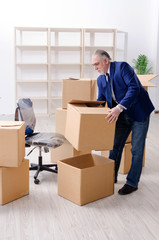 Aged businessman moving to new workplace 