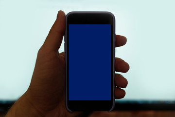 Male hand with a smartphone. Black blank screen. White background