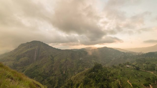 Sunset at Little Adam's peak in Ella Sri Lanka. Clouds rush by during golden hour in  a stunning 4K time-lapse from the touristic viewpoint