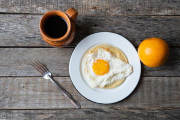 Mexican breakfast with egg, orange and coffee