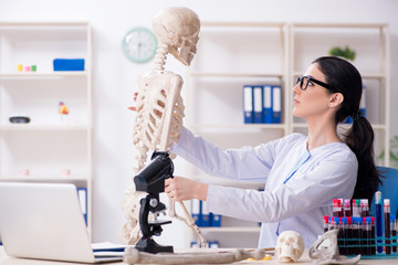 Young female archaeologist working in the lab 