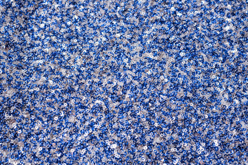 Fabric texture with white and blue sequins. Close-up.