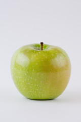 One single whole green apple isolated on white background