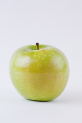 One single whole green apple isolated on white background