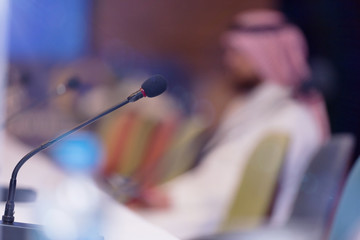 Front view of the microphones during business conference in conference room or hall, panel duscusion of economic development