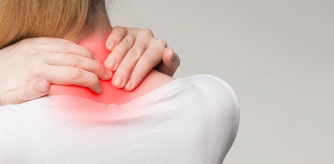Young woman feeling exhausted and suffering from neck pain