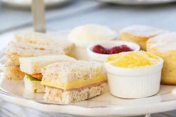 Sandwiches and butter scones on set English afternoon tea.