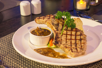 Grilled pork chop with mushroom sauce