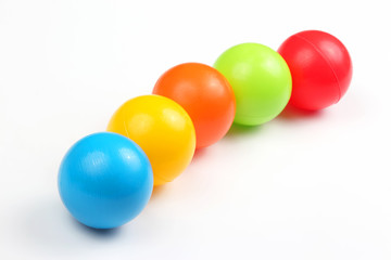 Colored plastic balls on white background