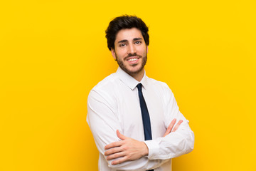 Businessman on isolated yellow background laughing