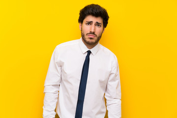 Businessman on isolated yellow background sad