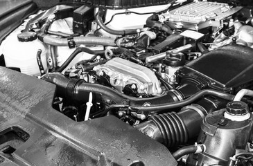 Car engine. Car engine part. Close-up image of an internal combustion engine. Engine detailing in a new car. Car detailing. Black and white