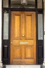 Wooden Entrance Door to residential building in London. Typical door in the English style.