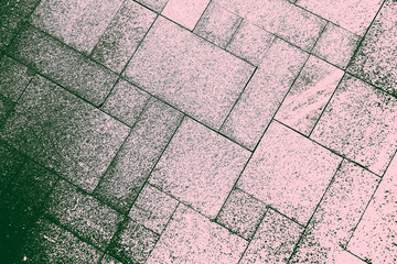 The sidewalk road made of natural stone is lined with mosaics of gray green color .Texture.