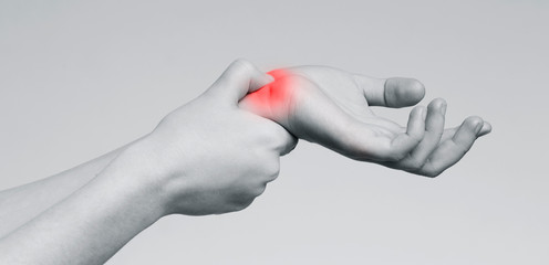 Woman suffering from wrist ache, monochrome photo