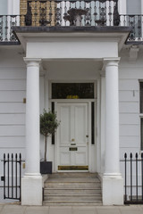 White Wooden Entrance Door to residential building in London. Typical door in the English style.