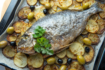 Baked sea bream with potatoes and olives